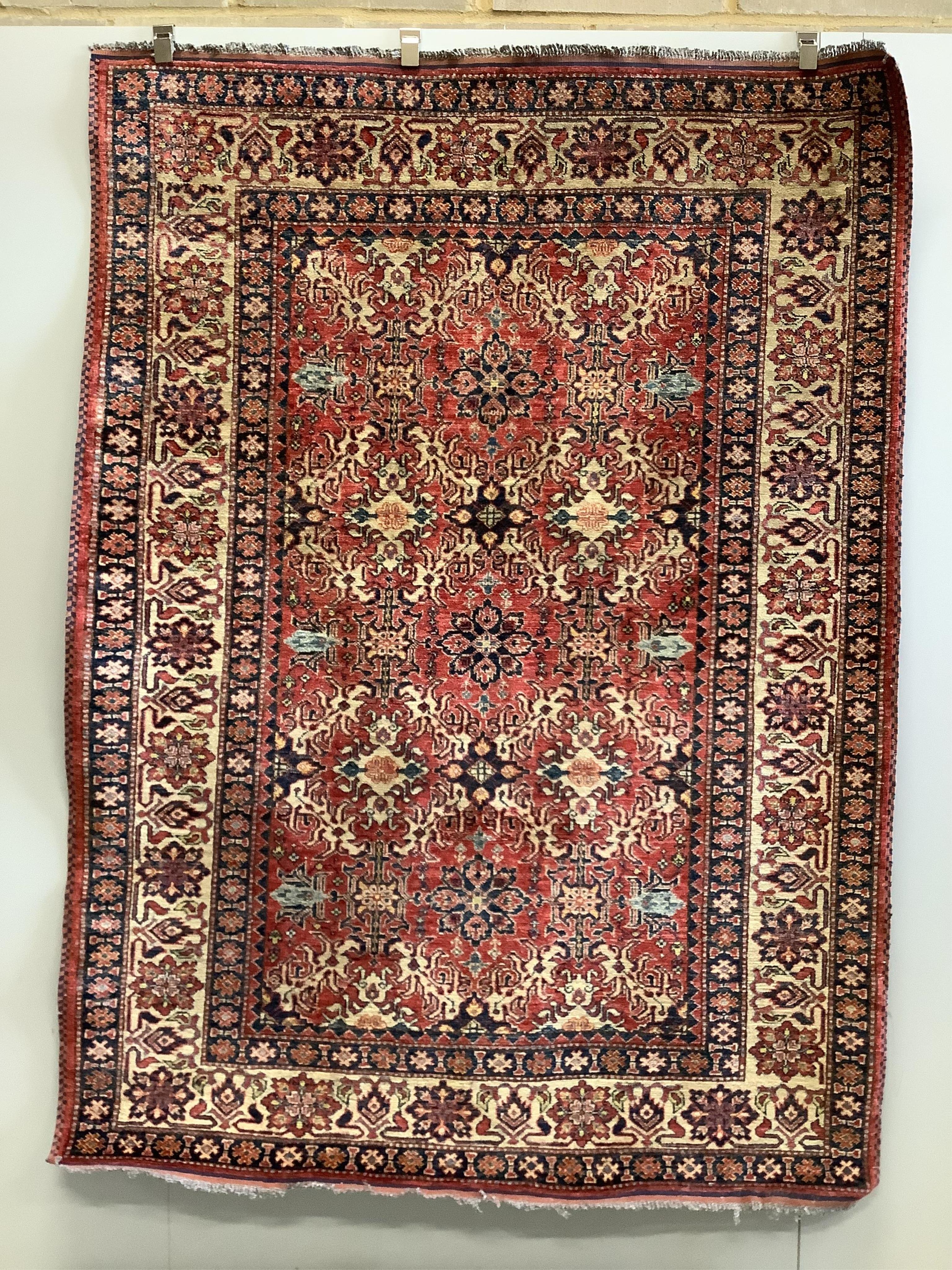 A Caucasian style red ground rug, 210 x 156cm
